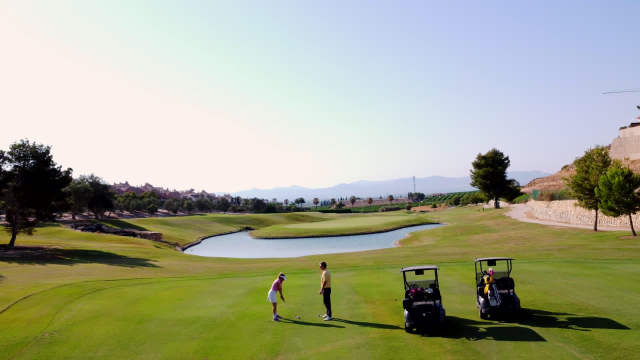 Golf Course with Golfers and Carts
