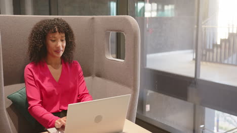 working on laptop, businesswoman in modern office, focusing on tasks