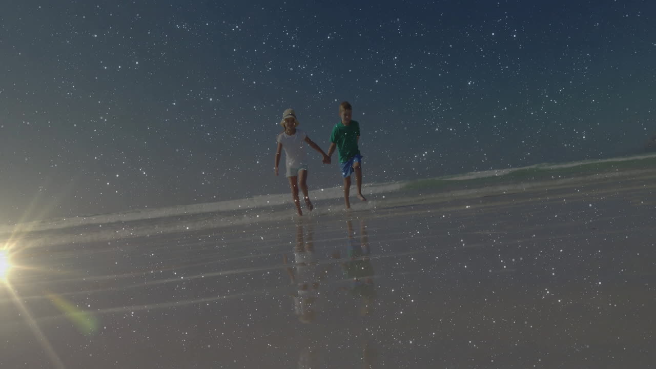 Children walking on beach with starry sky animation reflecting on water