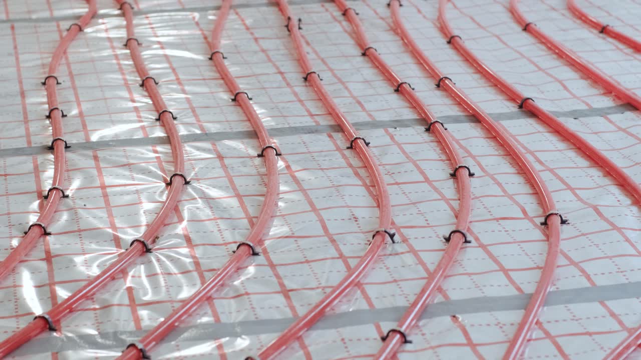 Installing underfloor heating pipes for water heating. Heating systems. Pipes for a heat-insulated floor.
