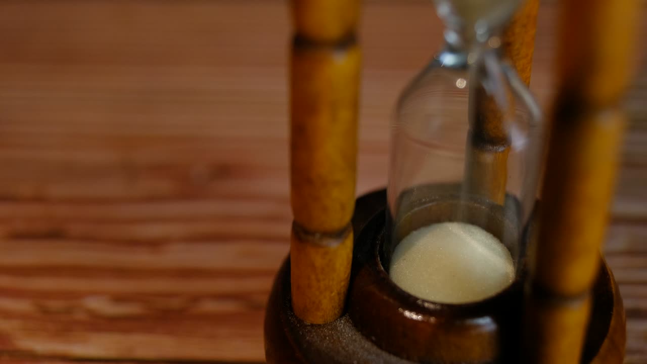 Close-up View of Sand in hourglass or sandglass for time counting down. for loop or repeat pattern.