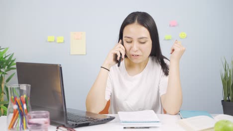 female student getting good news on the phone.