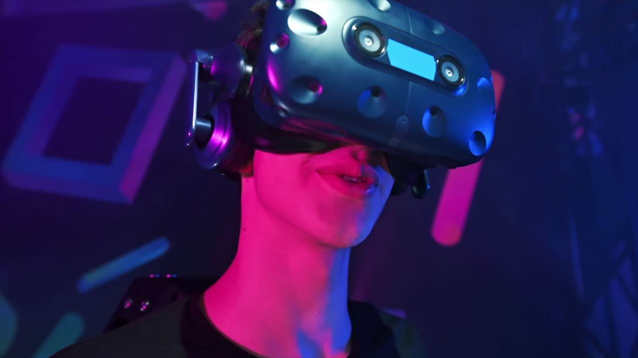 Close view of a joyful, smiling boy is playing on VR treadmill using helmet. Slow motion