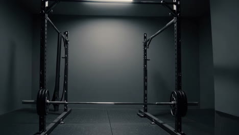 home gym setup with squat rack and barbell