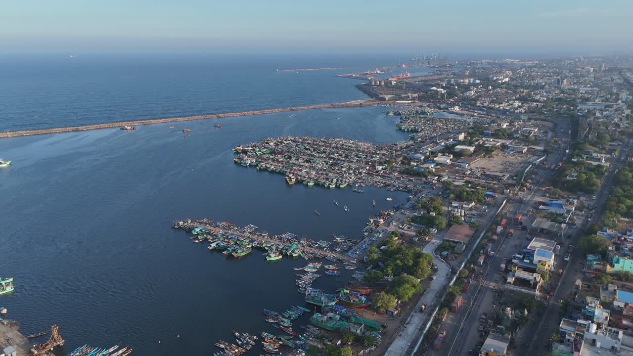 Aerial drone shot of ship harbour with fishing boats tied closely nearby