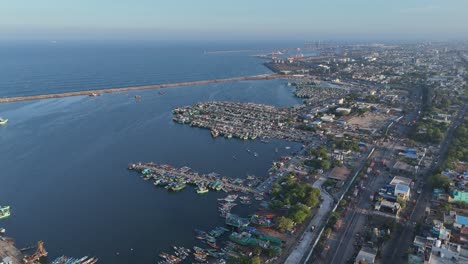 aerial drone shot of ship harbour with fishing boats tied closely nearby