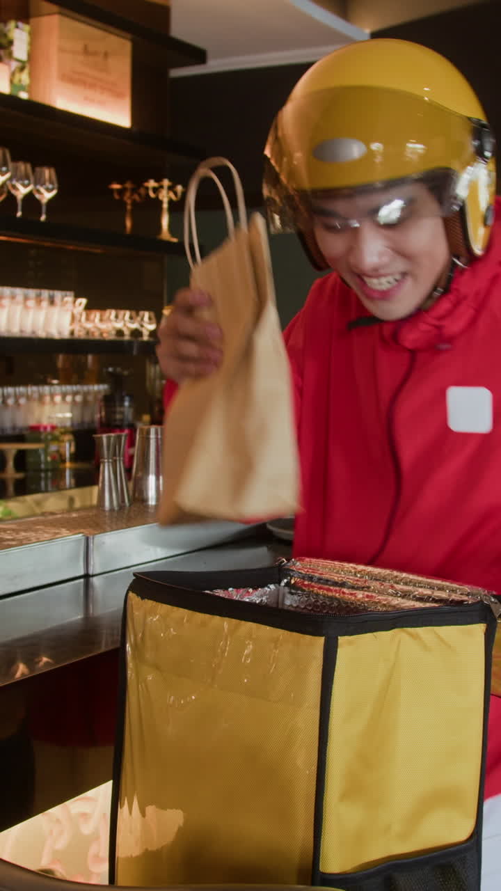 Fattorino che prende una borsa di cibo in un ristorante per il trasporto
