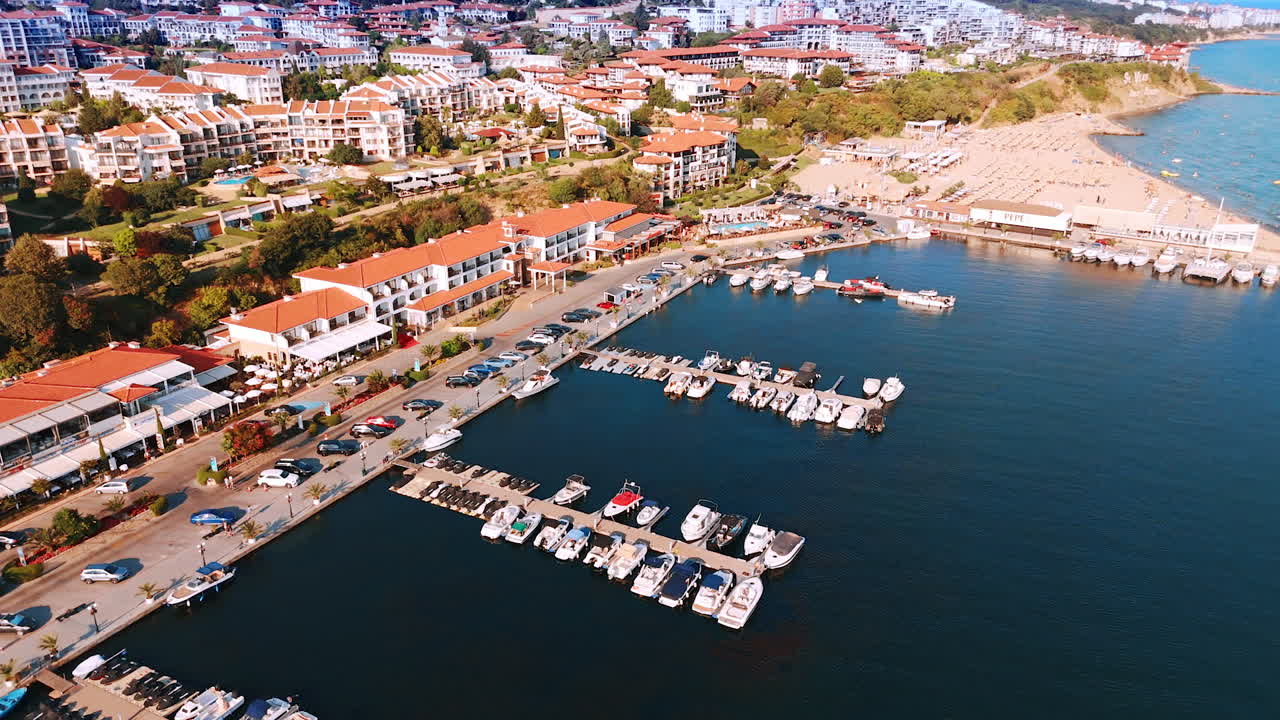 Multiple yachts and jet ski scooters are standing at the berths in the yacht club. Aerial view on the beautiful resort Sveti Vlas in sunny Bulgaria