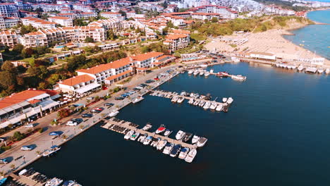 multiple yachts and jet ski scooters are standing at the berths in the yacht club. aerial view on the beautiful resort sveti vlas in sunny bulgaria