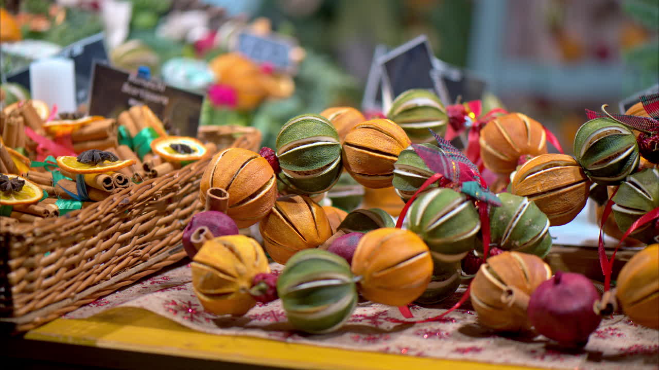 Close up of round Christmas decorations made out of cinnamon and oranges on display