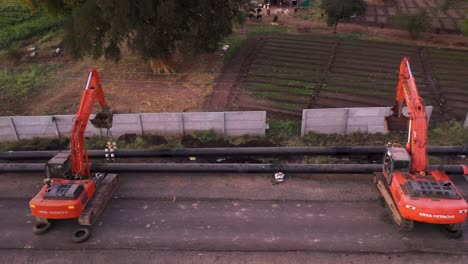 Aerial-Lateral-Shot-Of-Excavator-Trucks-Used-For-Pipeline-Work