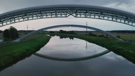 Flying-below-gas-pipes-across-calm-river-Morava-in-Slovakia