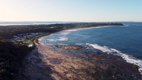 aerial drone landscape shot of rocky reef headland ocean waves rural town shelly beach bateau bay nature travel location tourism central coast nsw australia 4k