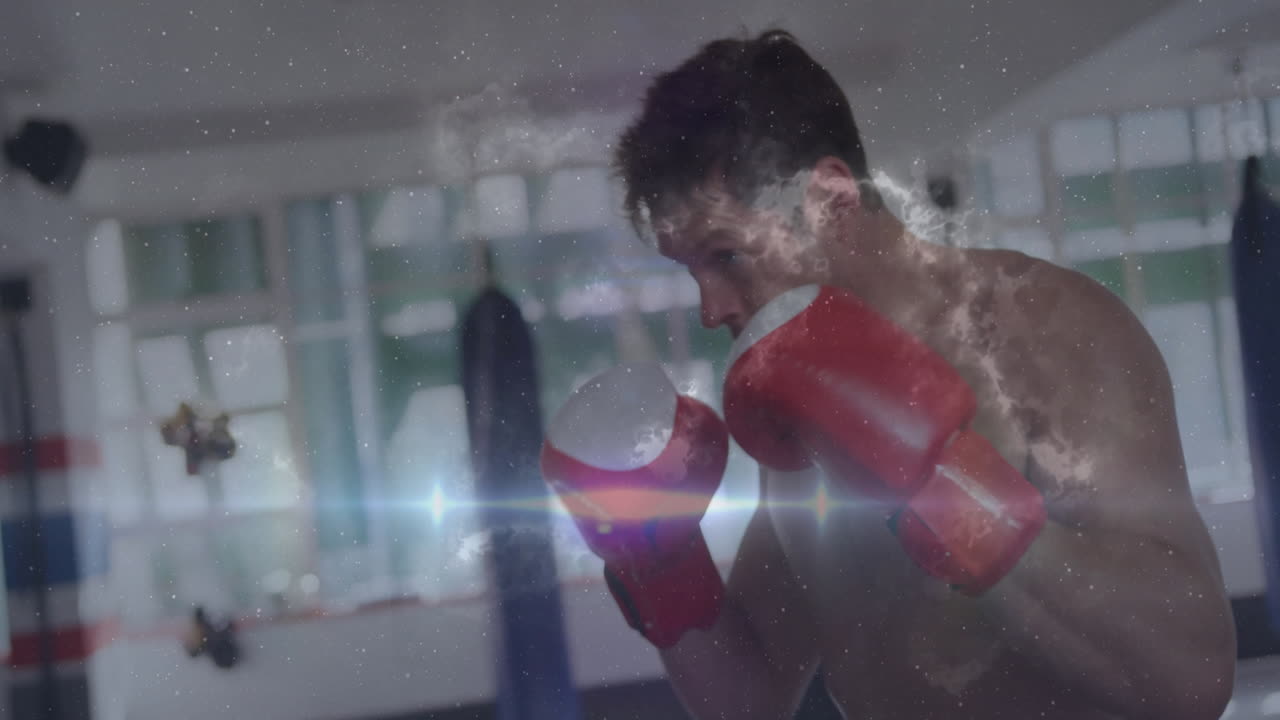 Boxer with red gloves punching bag over cosmic light and dust animation