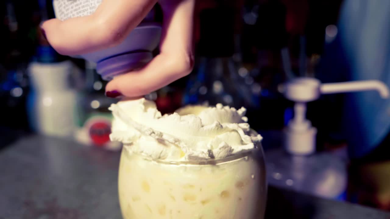 Making a cocktail with wipped cream in slow motion