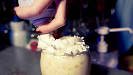 making a cocktail with wipped cream in slow motion