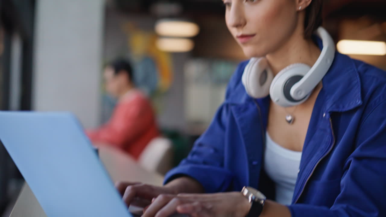 Woman hands writing notebook working laptop at modern coworking space closeup