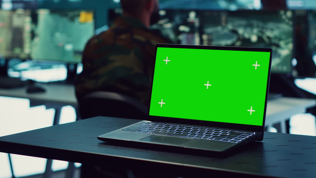 Laptop showing isolated mockup screen in army base of operations