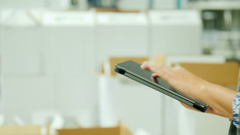 Woman's-Hands-Using-Tablet-by-White-Boxes