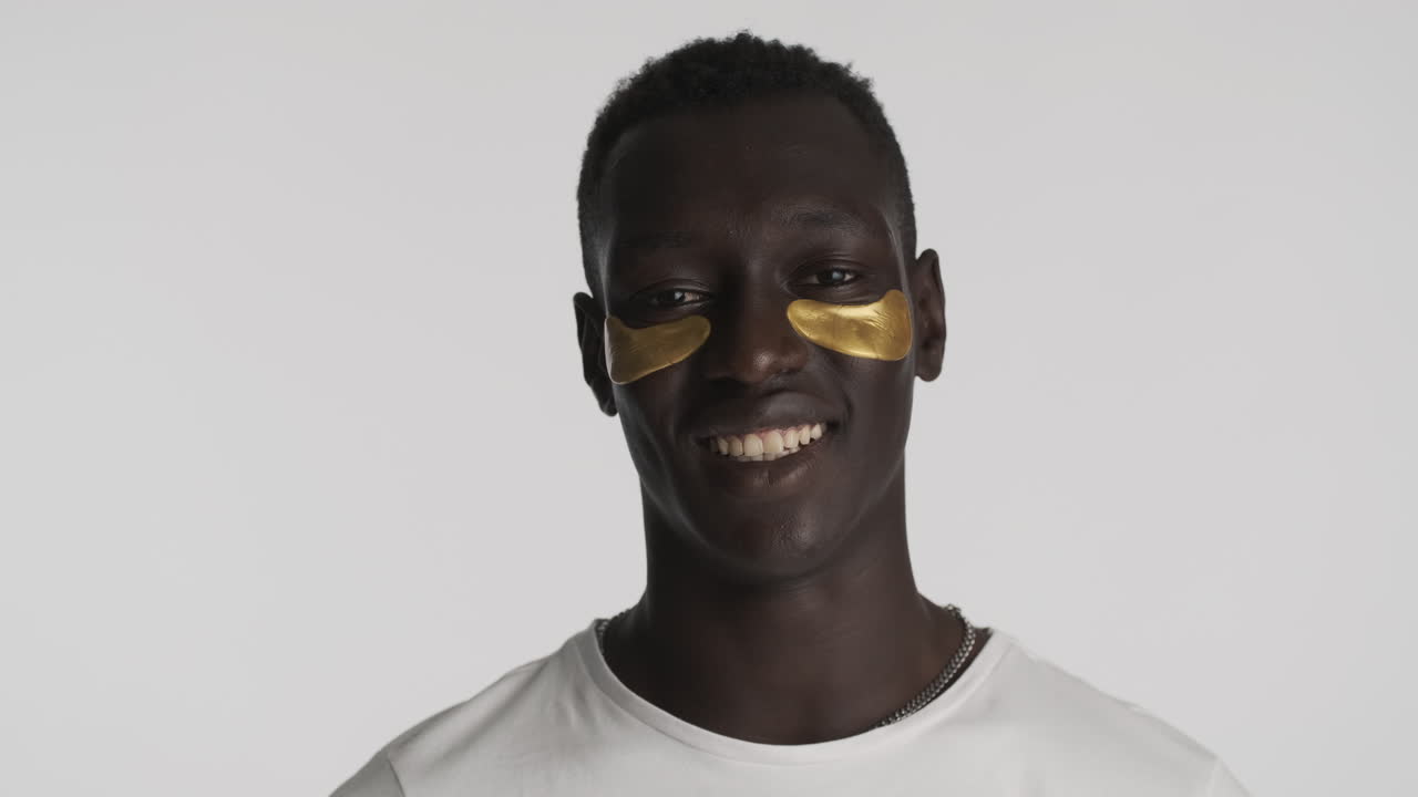 Happy African american man on grey background.