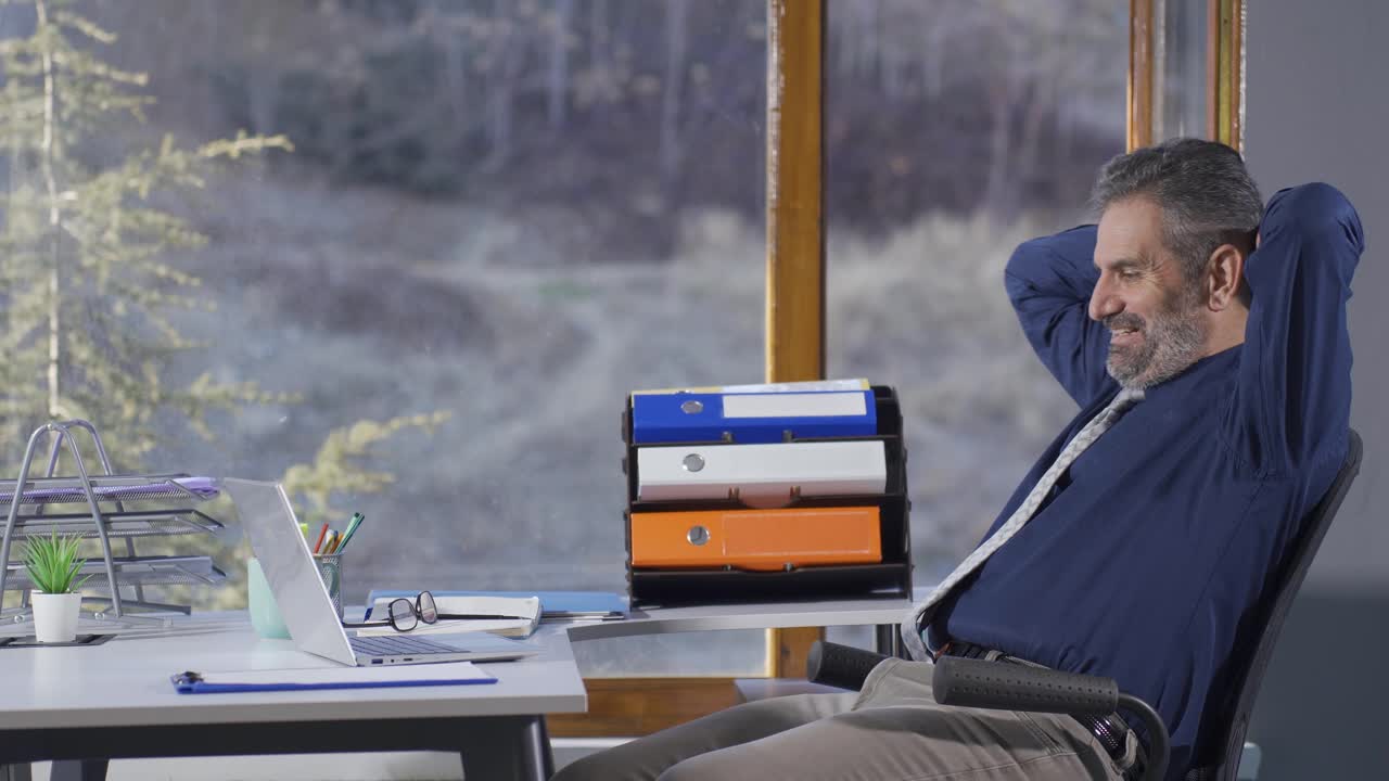 Mature businessman rejoicing at good news or emails on laptop screen. Rejoicing businessman in the office.