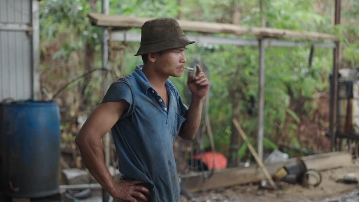 Worker Smoking Outside Workshop