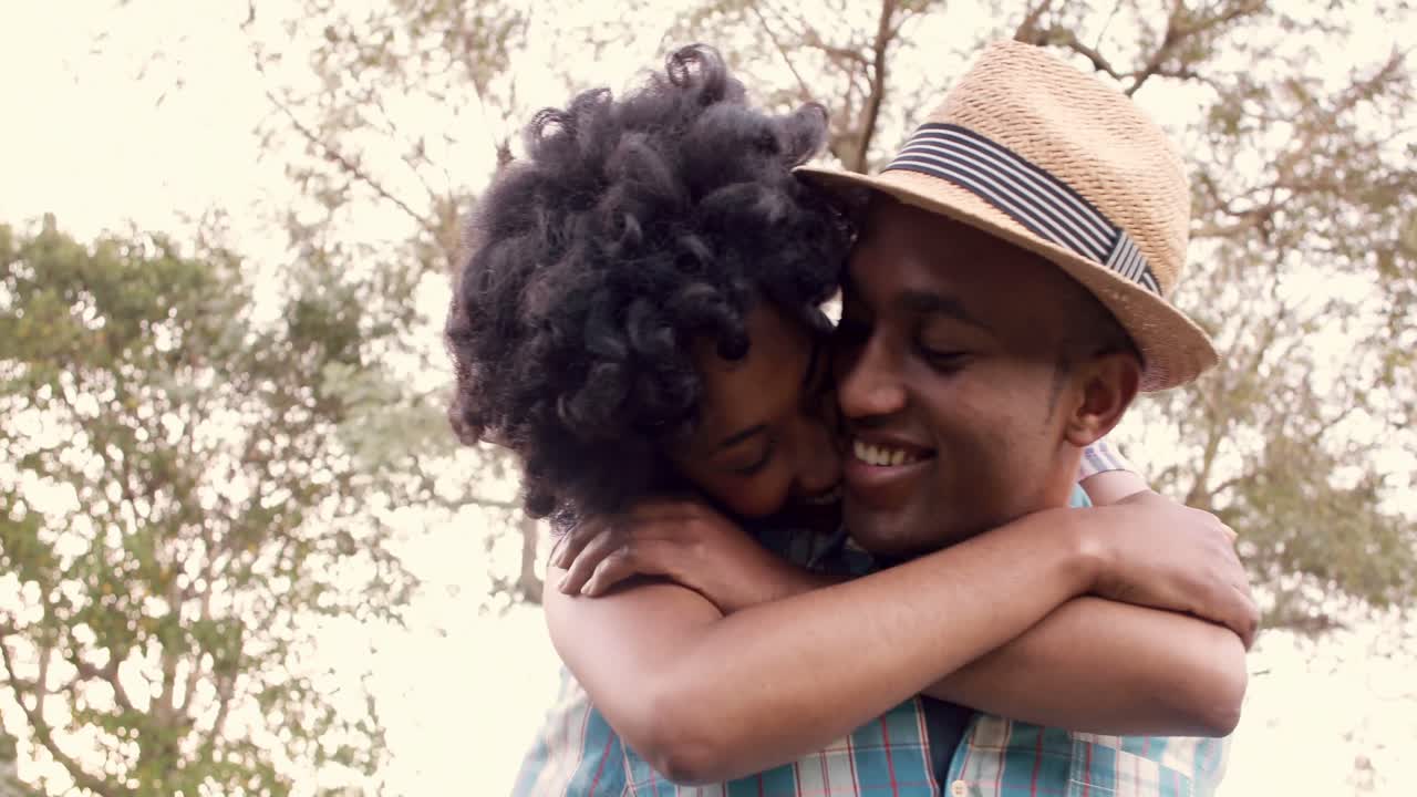 Handsome man giving piggy back to his girlfriend