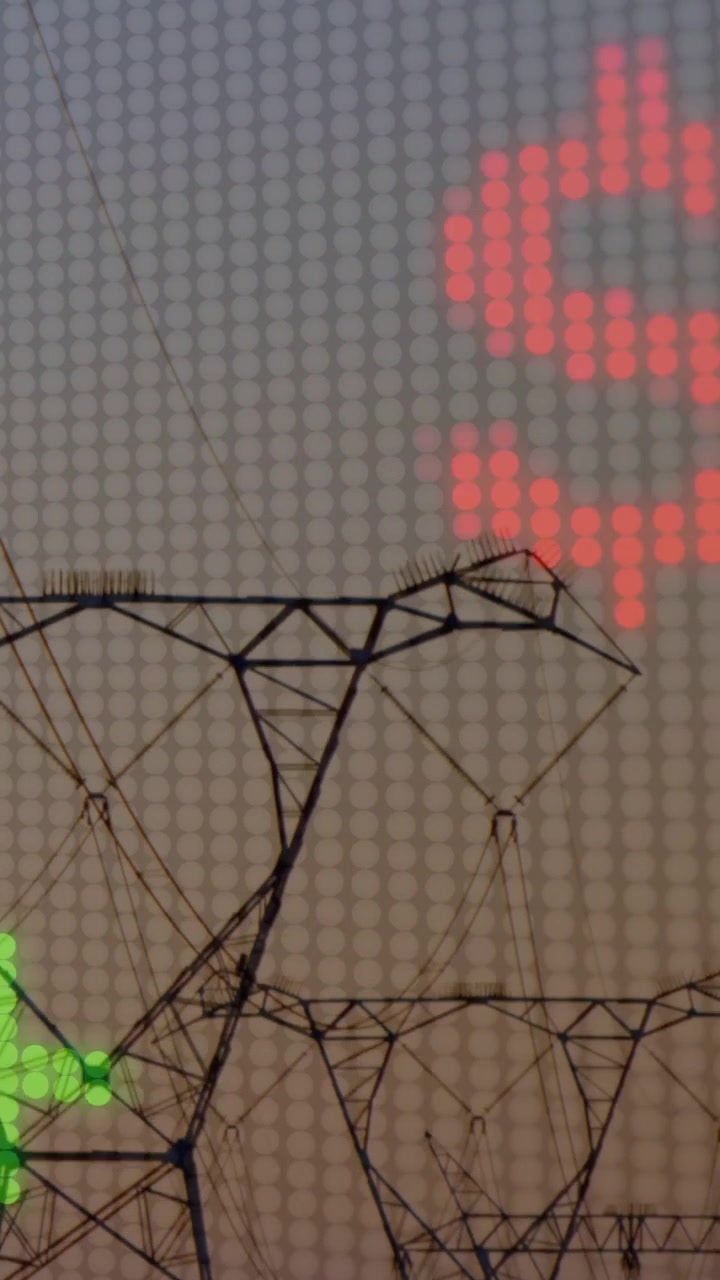 Vertical video: LED matrix on feed, scrolling red digits and green bars over towers, mapping energy