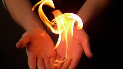 Woman-opening-hands-to-reveal-fire