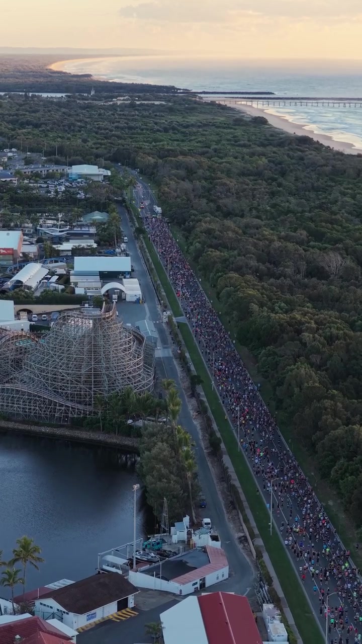 Vertical aerial footage dollying forward with a gentle downward tilt above the Gold Coast Marathon route in Southport, Queensland, Australia