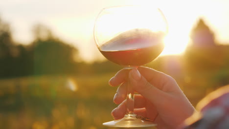 woman holding red wine glass