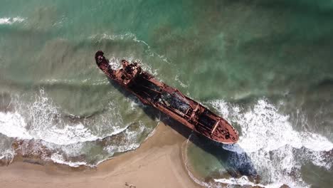 shipwreck dimitrios at valtaki beach, peloponnese, greece - aerial overhead ascending