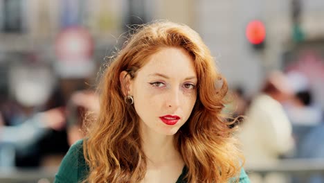 close-up portrait of a woman with red hair and freckles