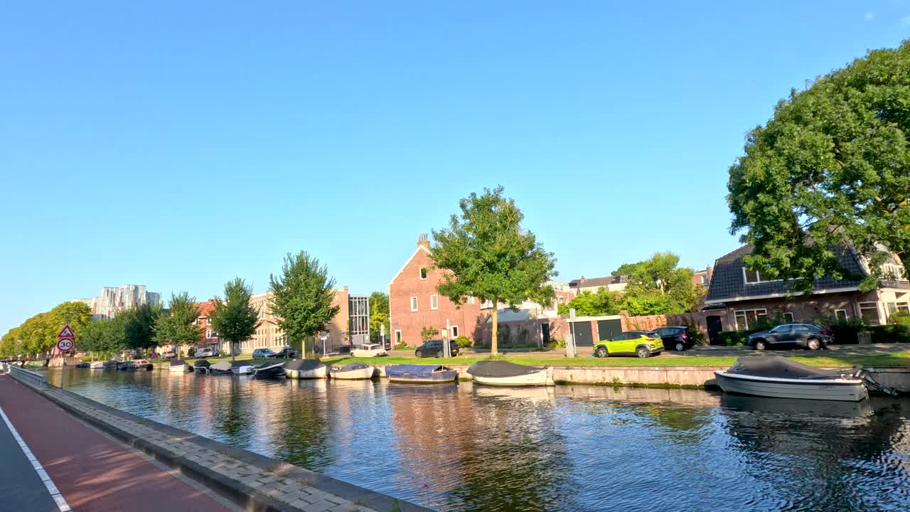 Canal with Boats and Trees in a Residential Area