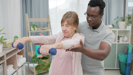 physiotherapy, arms and senior woman with black