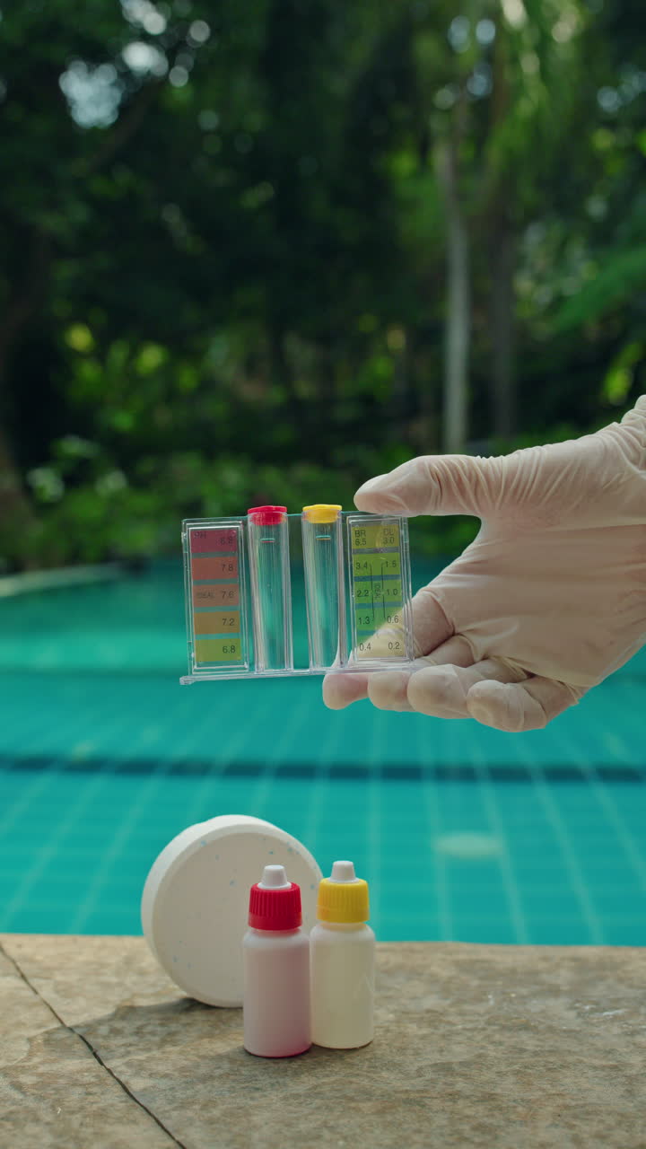 Gloved Hand Checking Swimming Pool Water Quality with Test Kit ...