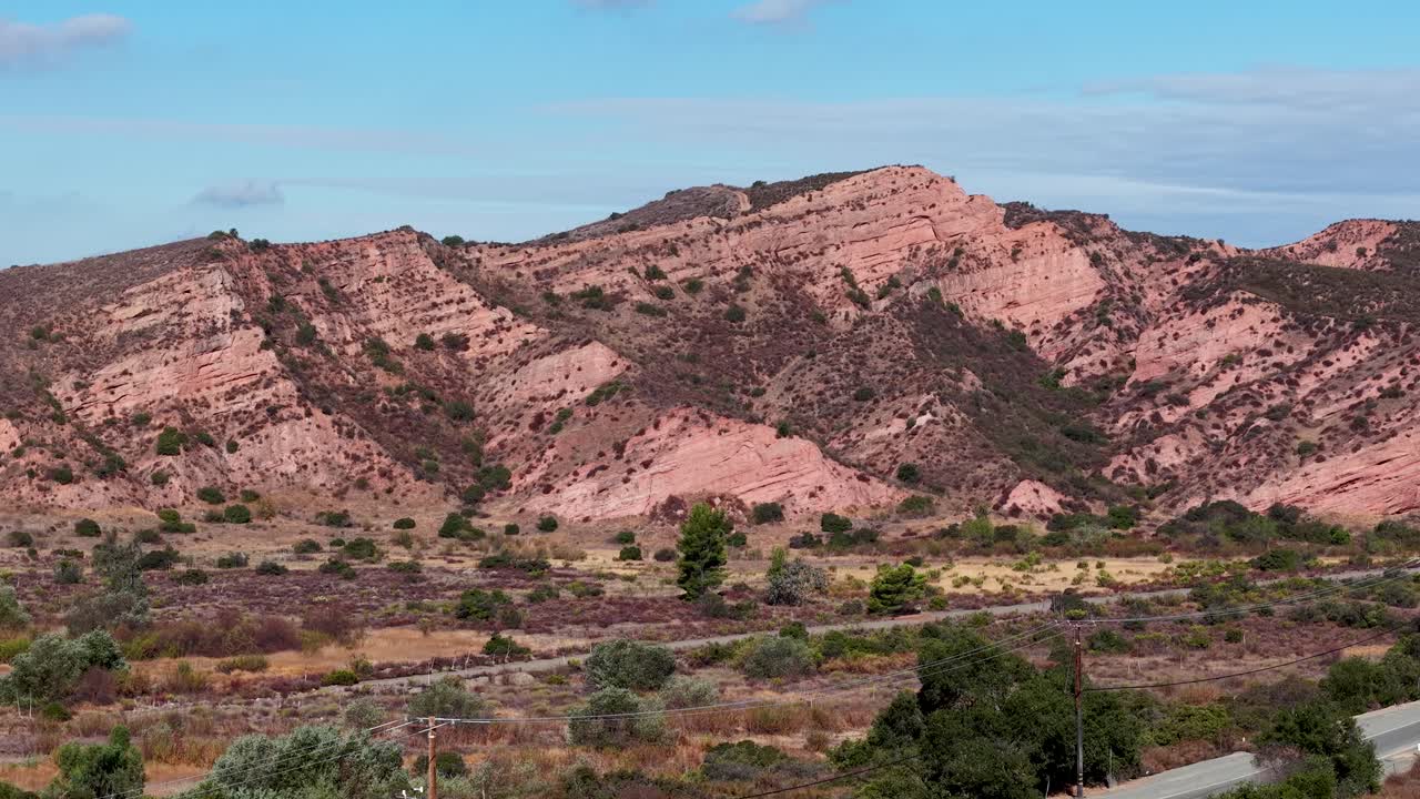 Cinematic aerial shot approaching exposed rock formations in Black Star Canyon, California