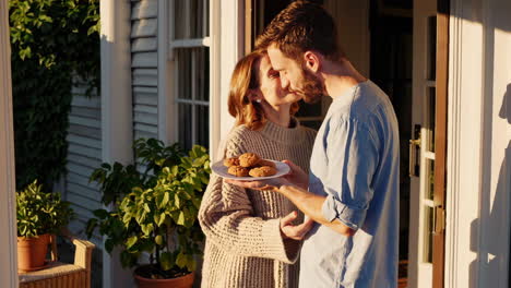 couple sharing cookies on a porch
