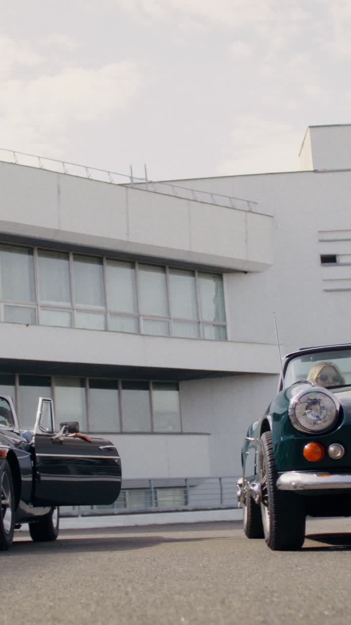 Couple by Vintage Convertible Cars