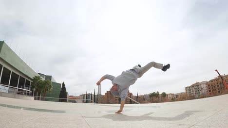 breakdancer performing handstand and cartwheel outdoors
