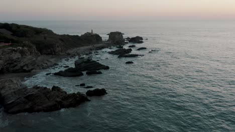 rocky coastline of puerto escondido hit by ocean waves in oaxaca, mexico