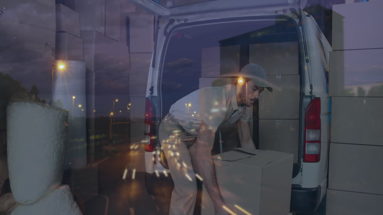 Animation of road traffic over delivery man loading boxes onto van in shipping centre