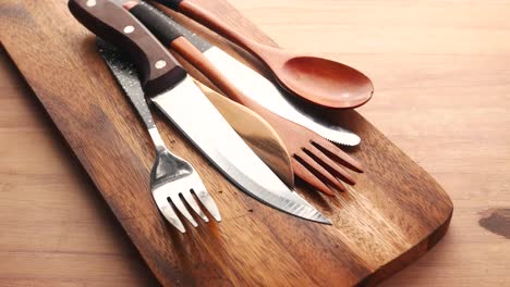 kitchen utensils on a wooden cutting board