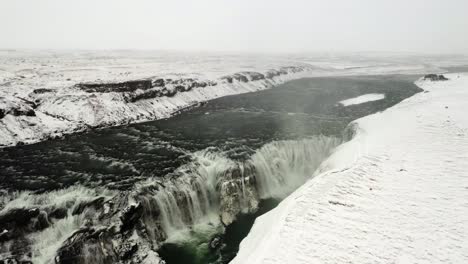 flying above powerfull gullfoss waterfall formed by glacial meltwater in iceland. orbit view
