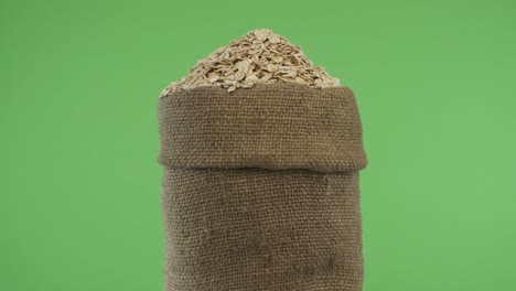 Rotating a full bag of oat flakes. Close-up.