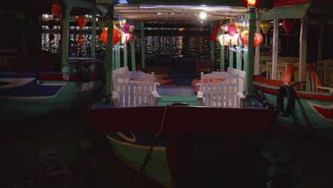 night shot of thu bồn river in hoi an , vietnam with a docked boat