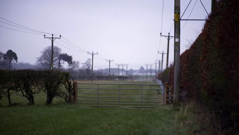 Shot-of-a-fence-running-along-a-field-on-a-farm