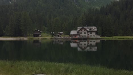 house's reflection in the lake in italy