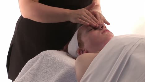 a woman receiving a facial massage