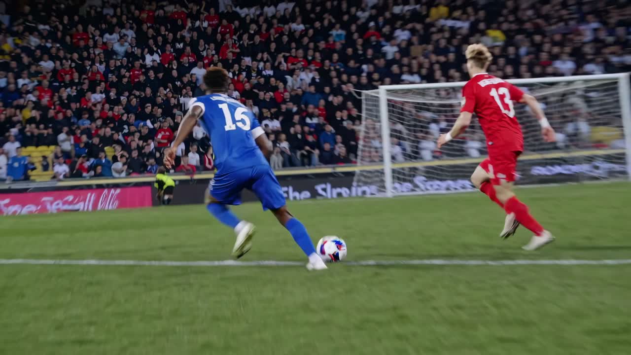 Wide-angle video capturing a dynamic soccer match with players in action, showcasing a lively